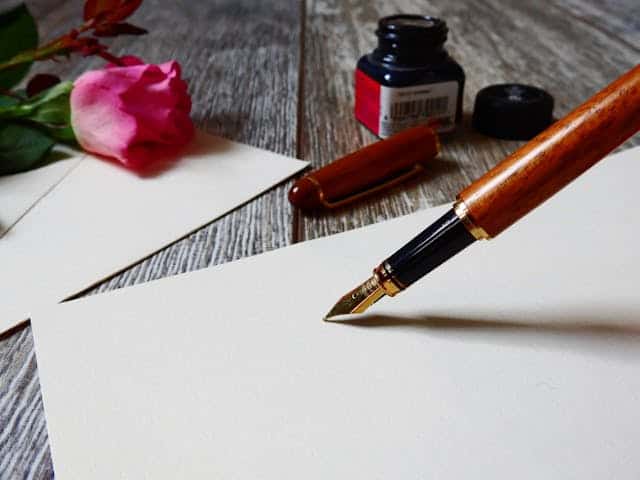 Image of paper, an old-fashioned nib pen, and ink bottle, and a rose.  Spine & Leaf Media provides copywriting for small business — blog posts, website copy, press releases, and ghostwriting, all written in your voice, not ours.