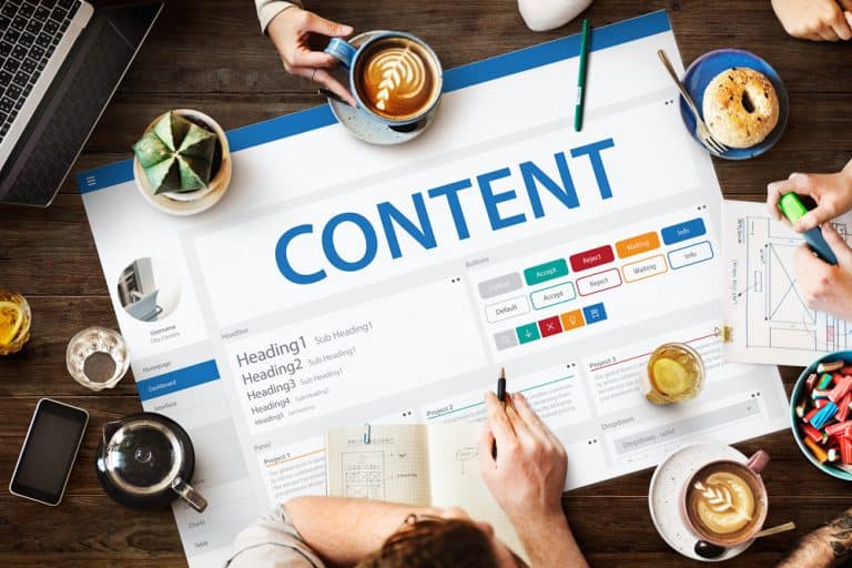 Affordable SEO for small business - picture of a team around a desk planning a new website.